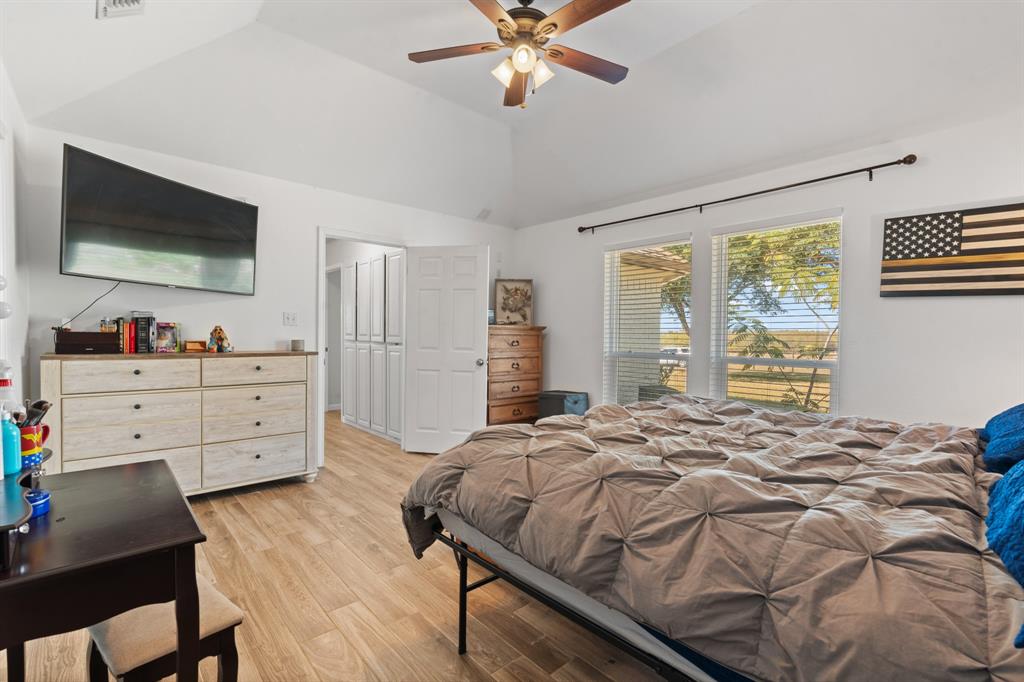 1013 Highland Road Cleburne, TX 76033 - Photo 24 of 33 a bedroom with a bed and a flat screen tv