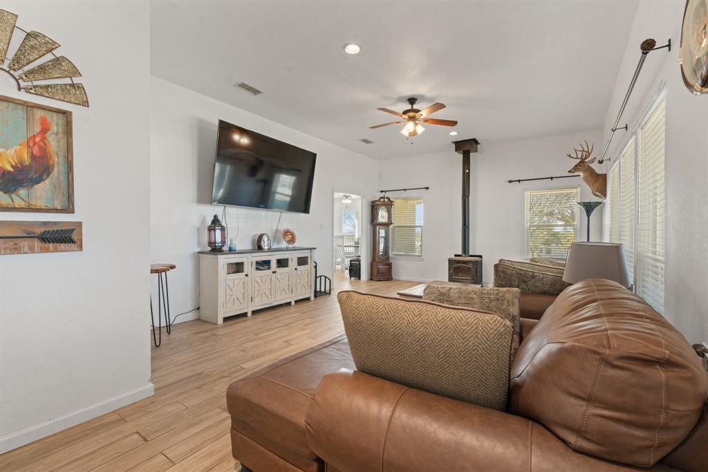 1013 Highland Road Cleburne, TX 76033 - Photo 5 of 33 a living room with furniture and a flat screen tv