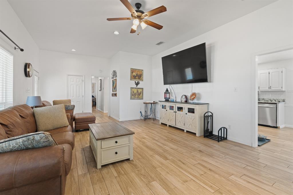 1013 Highland Road Cleburne, TX 76033 - Photo 8 of 33 a living room with furniture and a flat screen tv