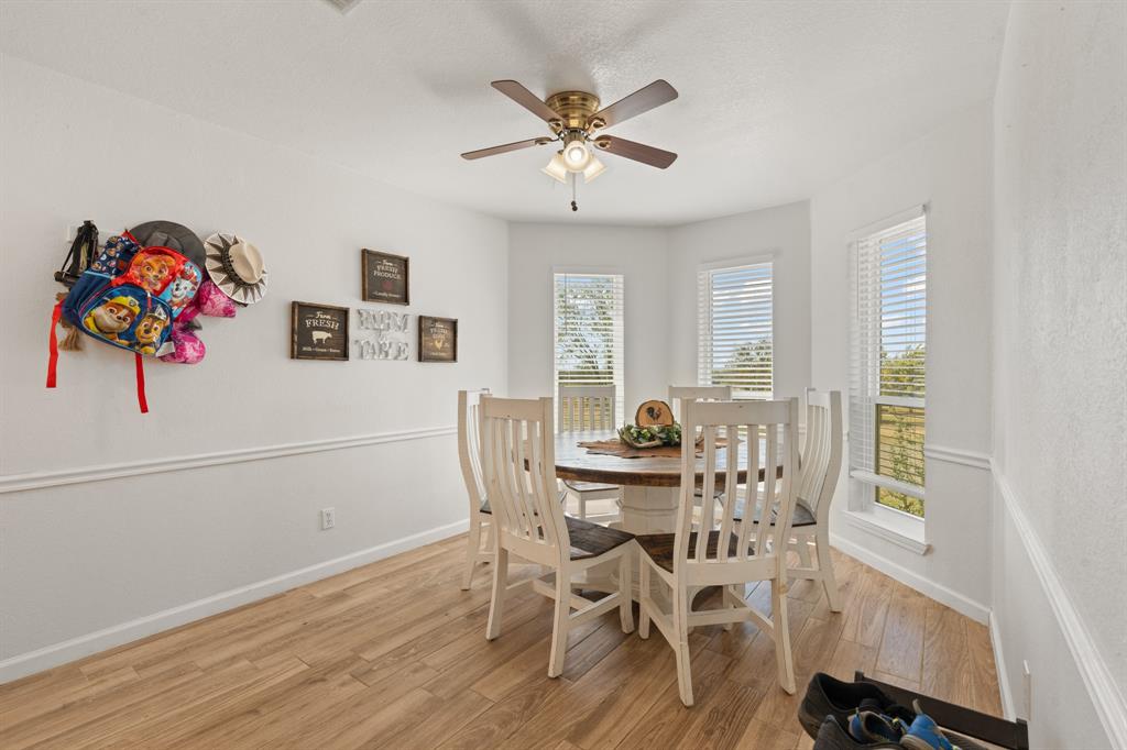 1013 Highland Road Cleburne, TX 76033 - Photo 9 of 33 a view of a dining room with furniture and wooden floor