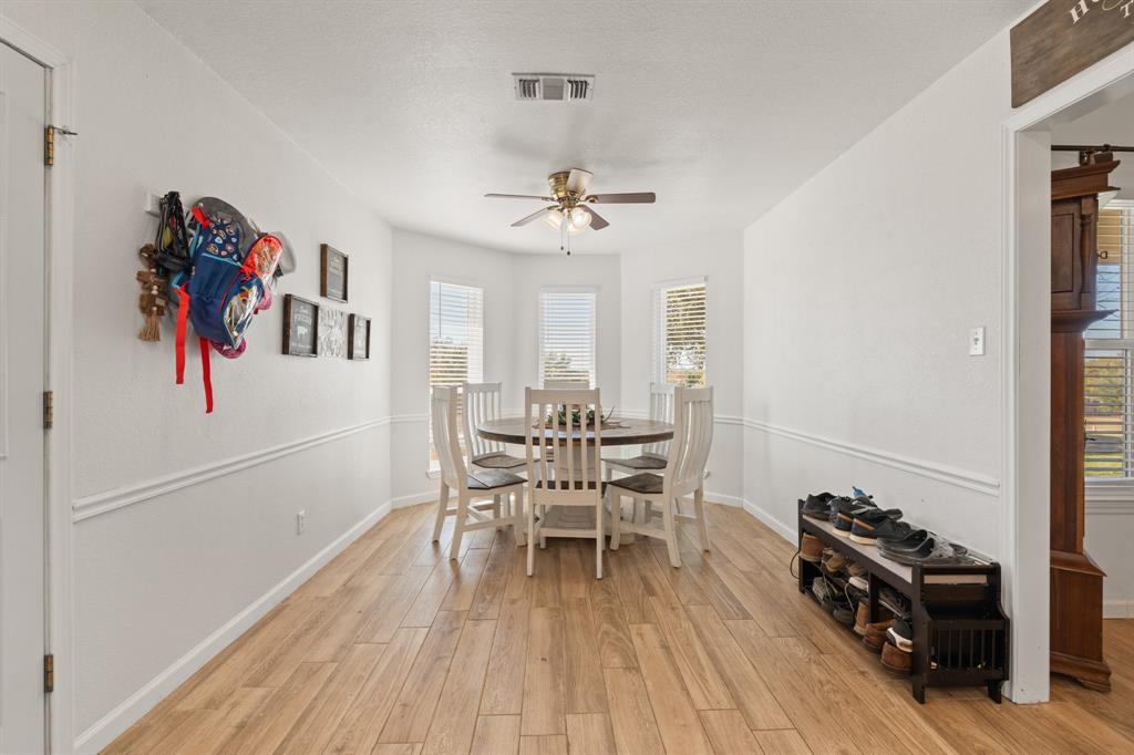 1013 Highland Road Cleburne, TX 76033 - Photo 10 of 33 a view of a dining room with furniture window and wooden floor