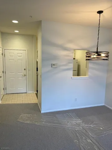 a view of kitchen with stainless steel appliances wooden floor