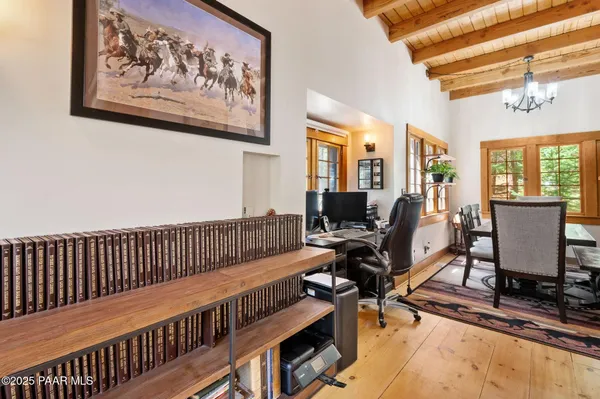 a view of a workspace with furniture and a window