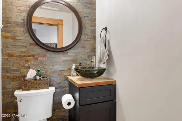 a bathroom with a toilet and a mirror