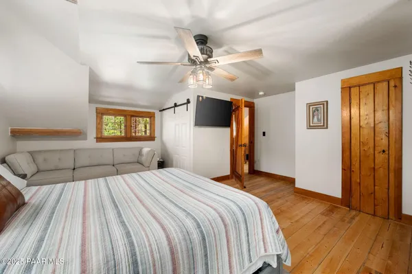 a bedroom with a large bed and a chandelier