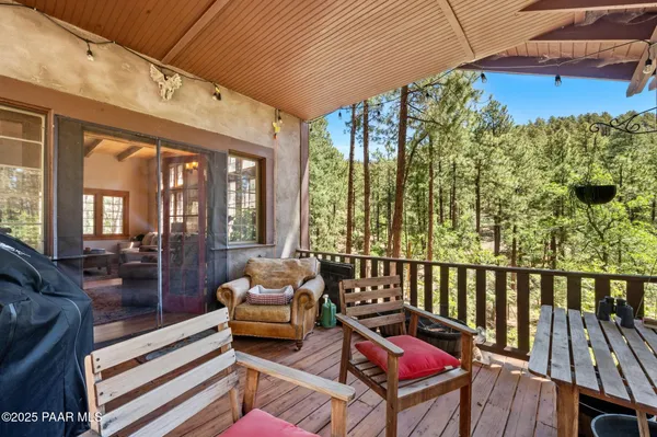 a balcony with furniture and wooden floor
