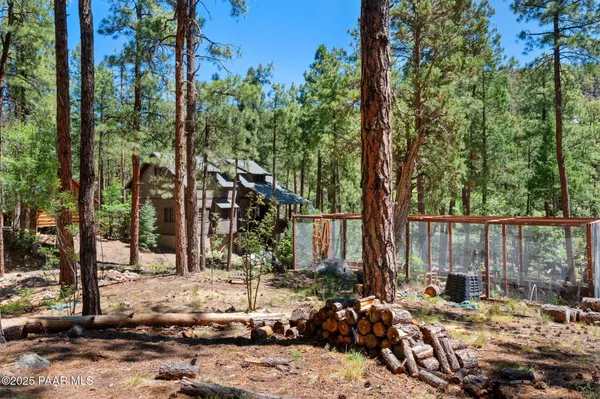 a view of backyard with a table and chairs and wooden fence