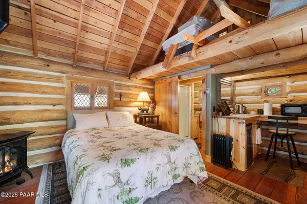 a bed sitting in a bedroom next to a window