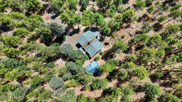 an aerial view of a house with a yard
