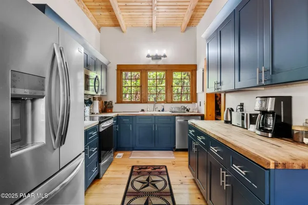 a kitchen with stainless steel appliances granite countertop a stove a sink and a refrigerator