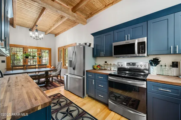 a kitchen with stainless steel appliances a stove microwave and refrigerator