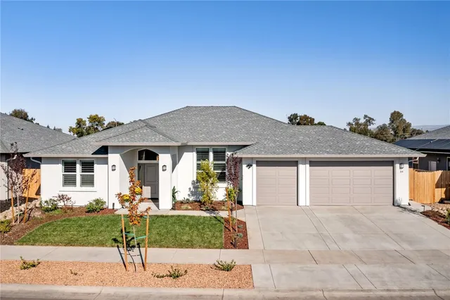 a front view of a house with a yard and garage