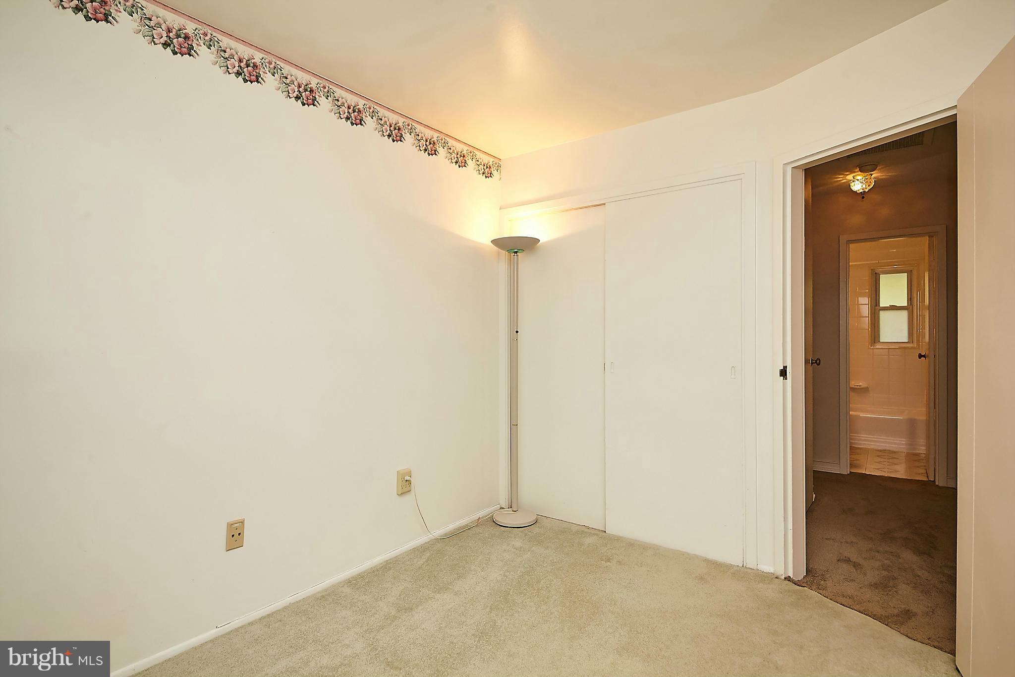 5540 Earlehurst Street Springfield, VA 22151 - Photo 19 of 30 a view of a bathroom with a shower and a glass door