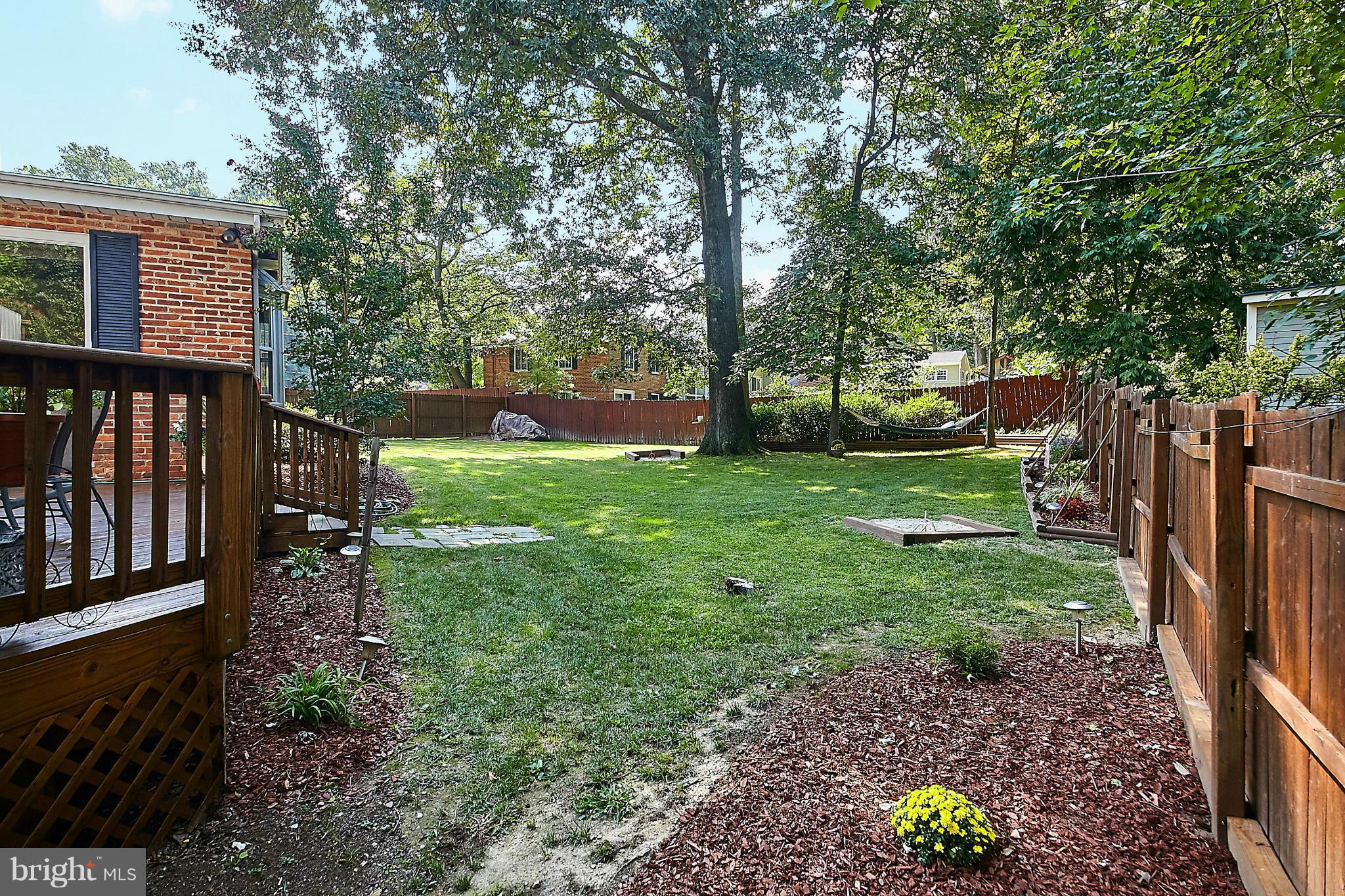 5540 Earlehurst Street Springfield, VA 22151 - Photo 26 of 30 a view of a backyard with wooden fence and large trees