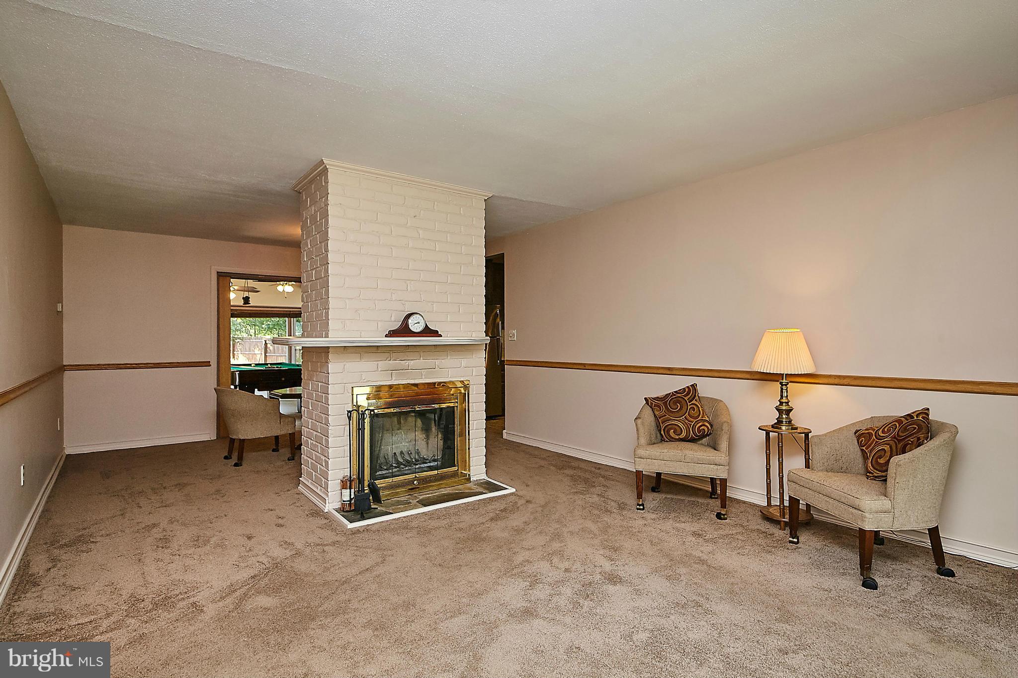 5540 Earlehurst Street Springfield, VA 22151 - Photo 6 of 30 a living room with furniture and a fireplace