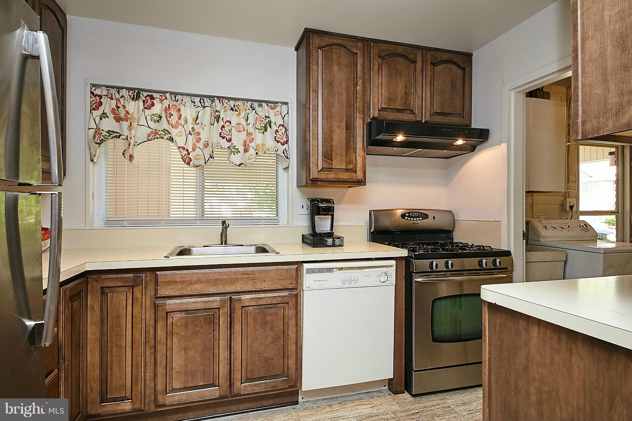 5540 Earlehurst Street Springfield, VA 22151 - Photo 7 of 30 a kitchen with stainless steel appliances granite countertop a sink stove and refrigerator
