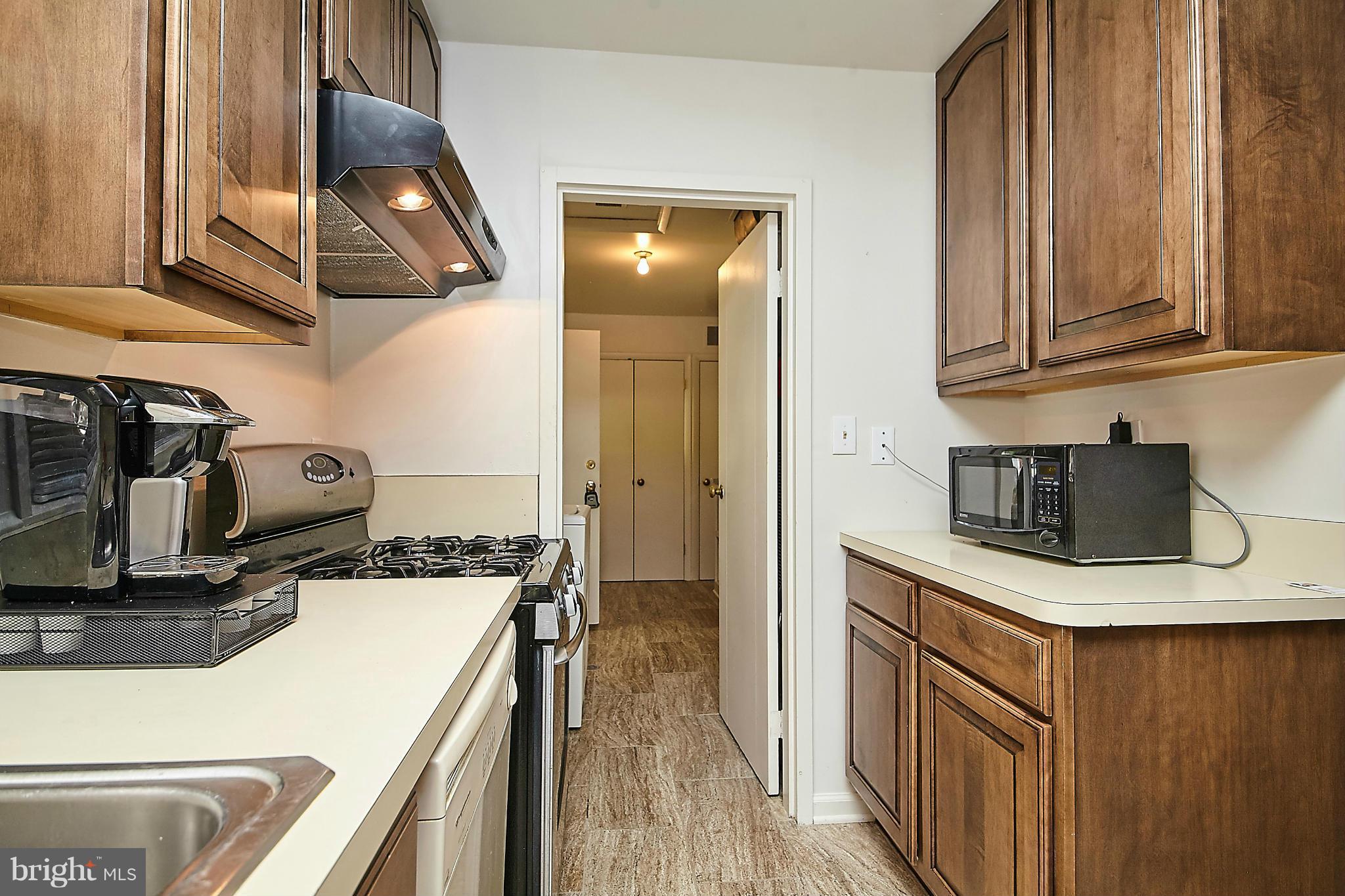 5540 Earlehurst Street Springfield, VA 22151 - Photo 9 of 30 a kitchen that has a lot of cabinets and wooden floor