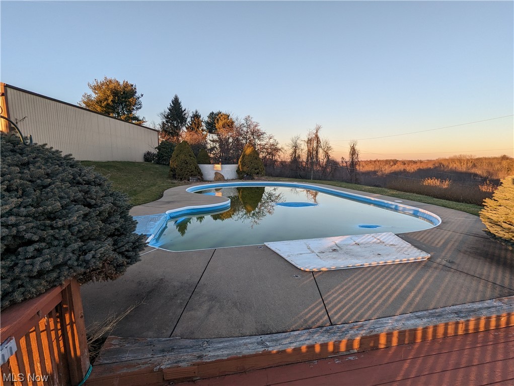 53154 Key Bellaire Road Bellaire, OH 43906 - Photo 5 of 43 Pool at dusk featuring a patio area