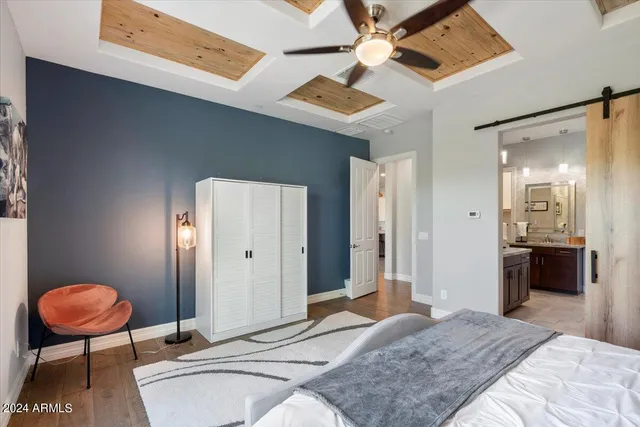 a bedroom with a large bed and a chandelier