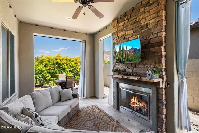 a living room with furniture a flat screen tv and a fireplace