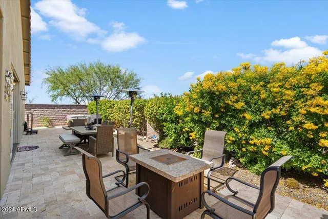 a backyard of a house with table and chairs