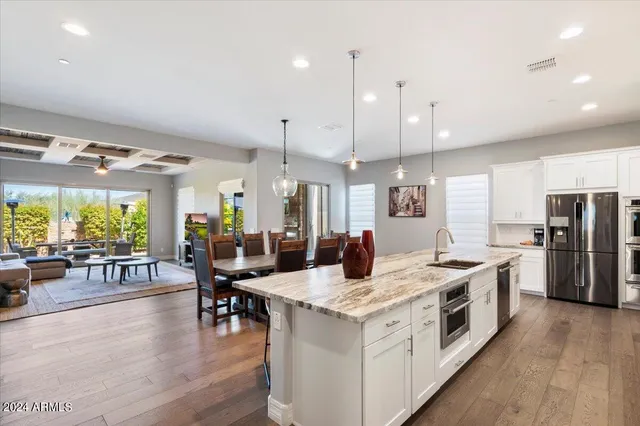 a large kitchen with a table and chairs