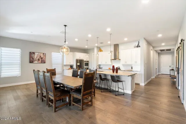a large kitchen with a table and chairs