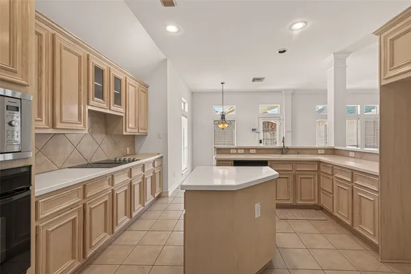 a kitchen with stainless steel appliances granite countertop a sink and cabinets
