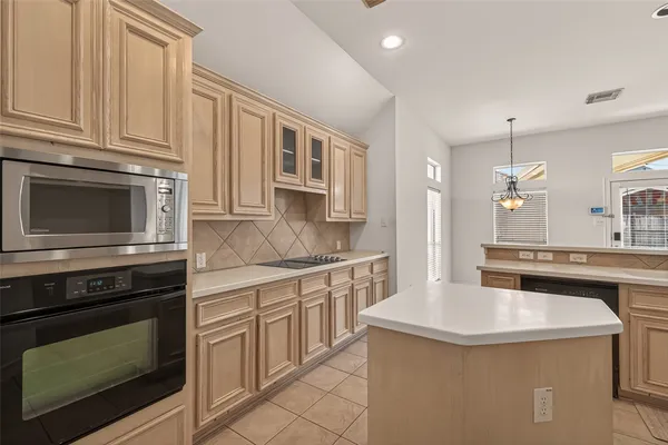 a kitchen with stainless steel appliances a stove sink and cabinets