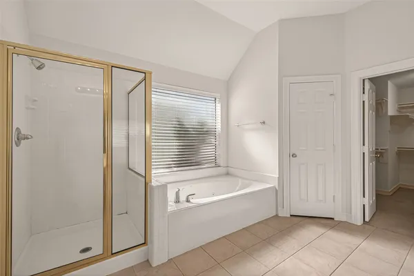 a bathroom with a bathtub and a shower