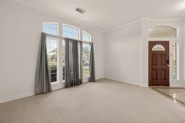 an empty room with windows and closet