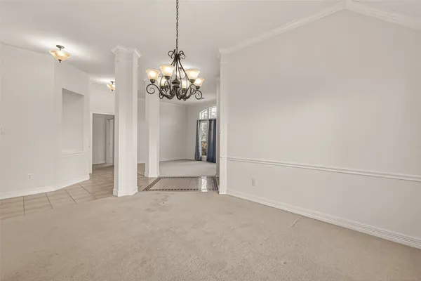 a view of a chandelier in big room and chandelier