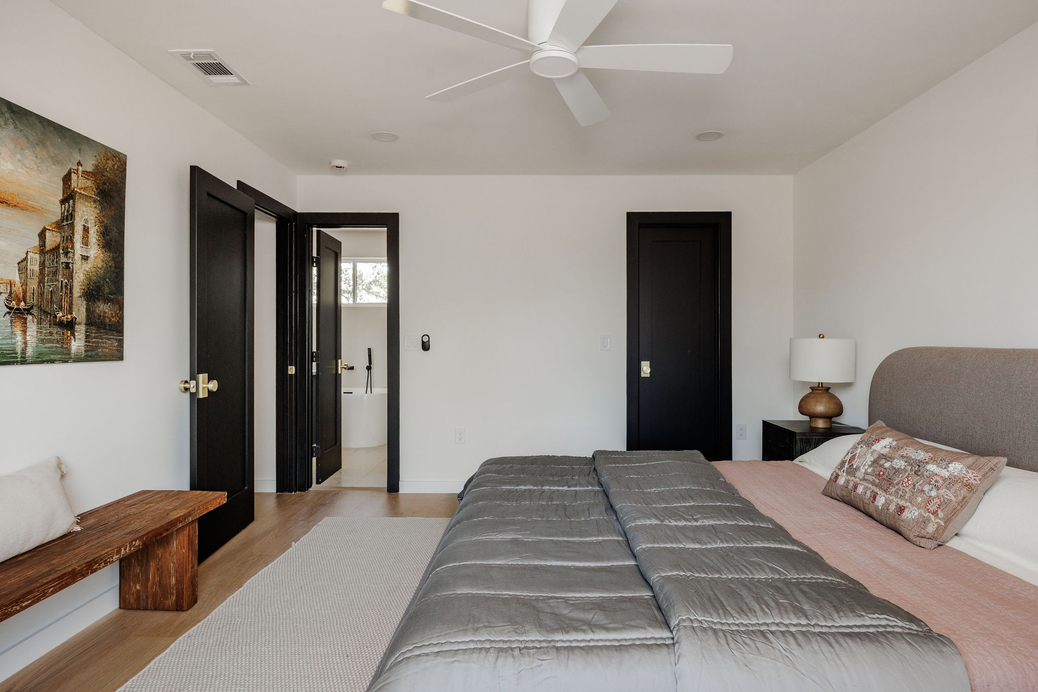 2210 Comburg Castle Way Austin, TX 78748 - Photo 25 of 40 a bedroom with a large bed and a chandelier