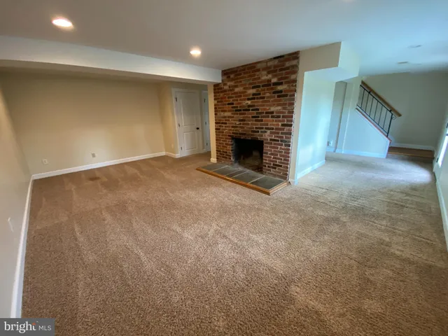 a view of empty room with a fireplace