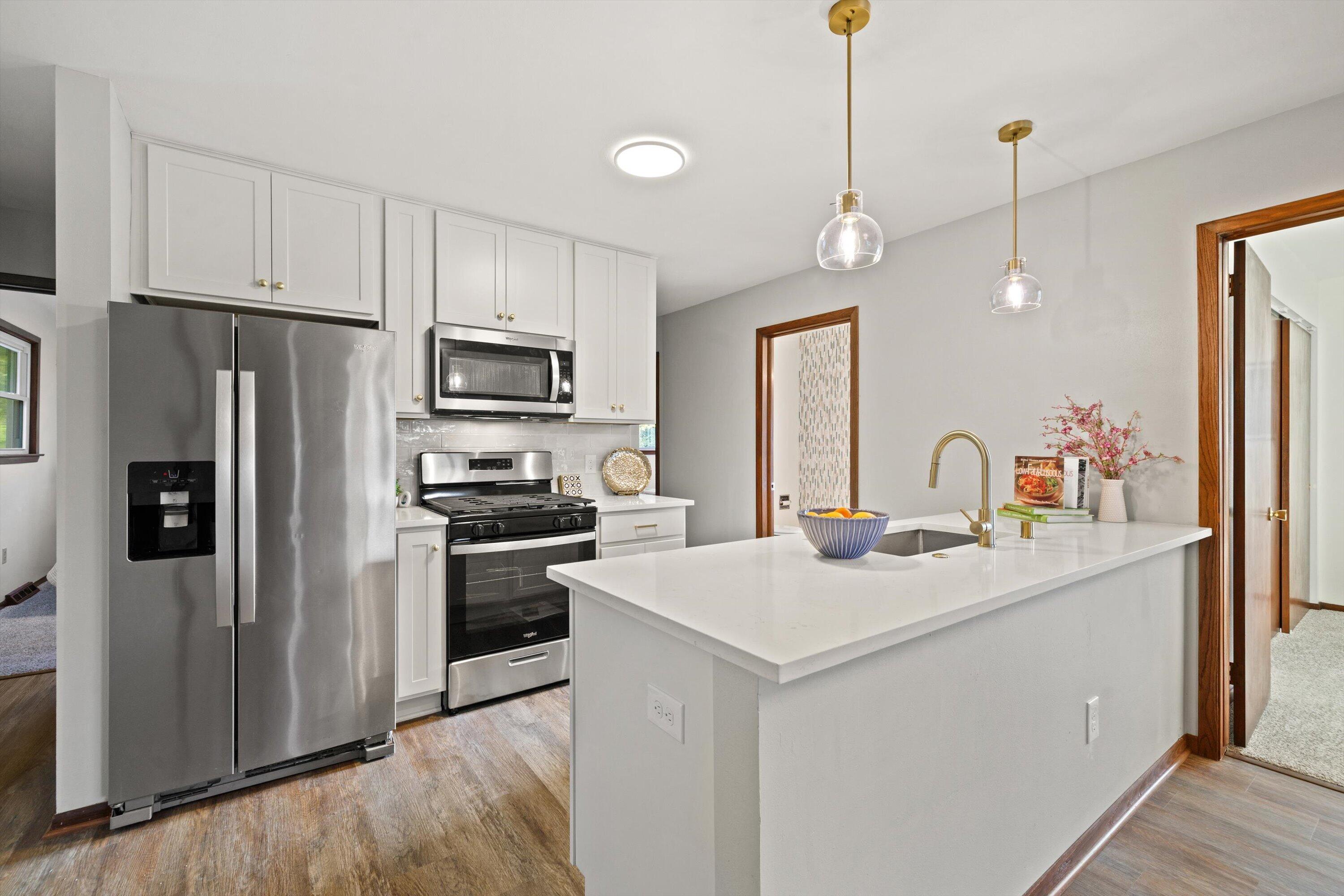 726 Royal Park Road Caledonia, WI 53402 - Photo 5 of 29 Updated kitchen features crisp white cabinetry, stainless appliances, and a bright, functional layout ready for daily use