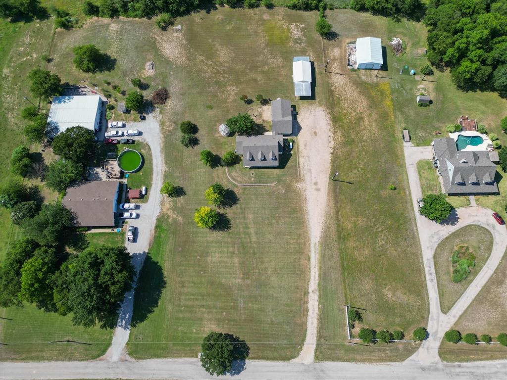 289 County Road 4655 Rhome, TX 76078 - Photo 29 of 34 Expansive property featuring multiple structures, open land, and mature trees
