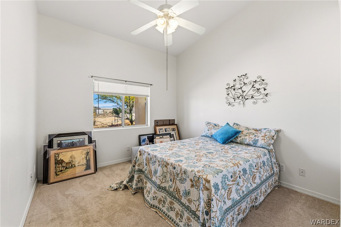 9332 Branded Road Kingman, AZ 86401 - Photo 24 of 44 a bedroom with a bed and a chandelier