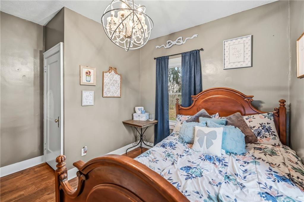 2411 Graceland Road New Castle, PA 16105 - Photo 20 of 50 a bedroom with a bed and a chandelier