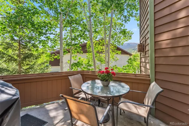 a table and chairs in patio of the house