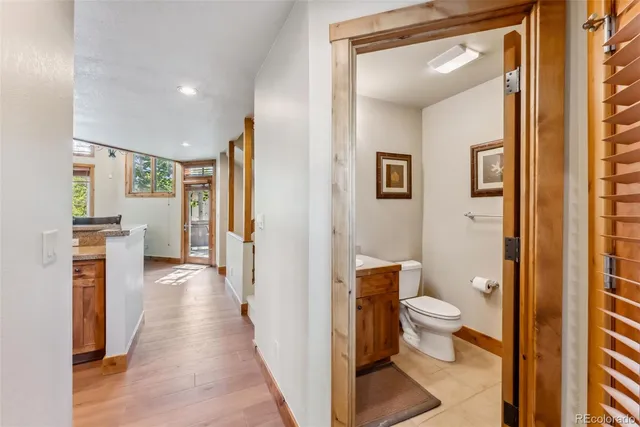 a bathroom with a toilet sink and a mirror
