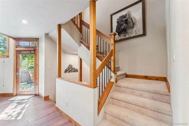a view of staircase with wooden floor and a rug