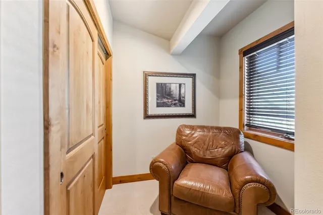 a blue couch sitting in a living room next to a window