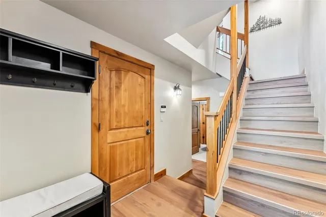 a view of entryway with wooden floor and stairs