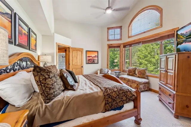 a bedroom with a bed and a large window