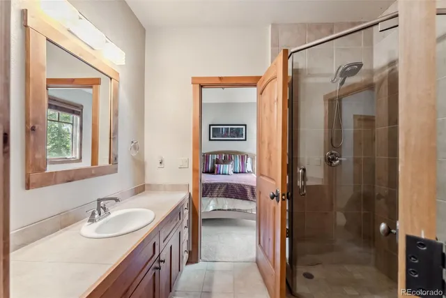 a bedroom with two beds and a large window