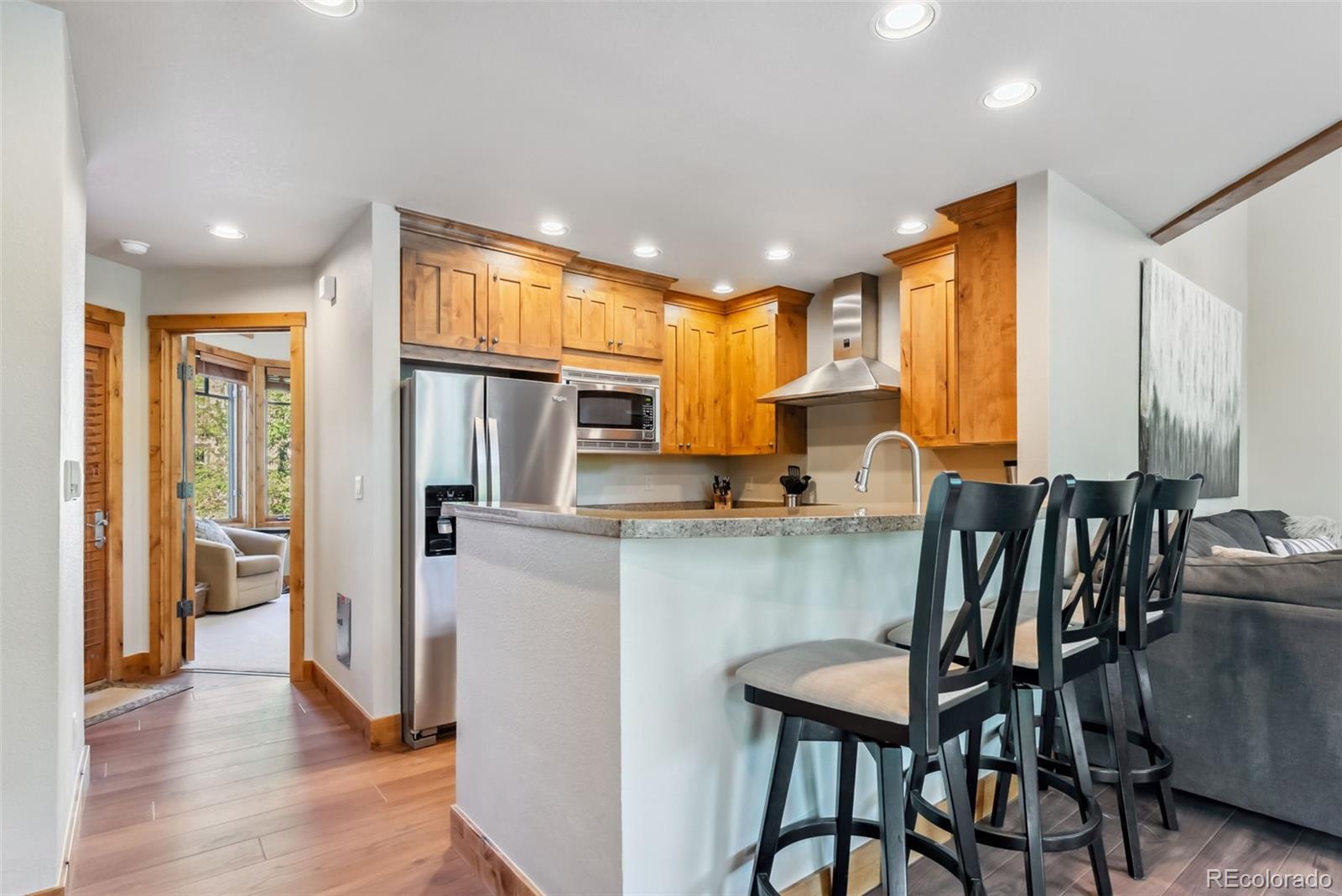 0024 Rasor Drive Dillon, CO 80435 - Photo 9 of 37 a kitchen with stainless steel appliances granite countertop a dining table chairs refrigerator and sink