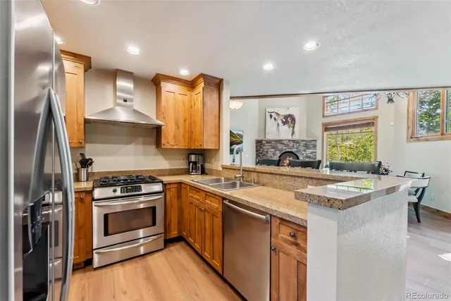 a kitchen with a stove a sink and a refrigerator