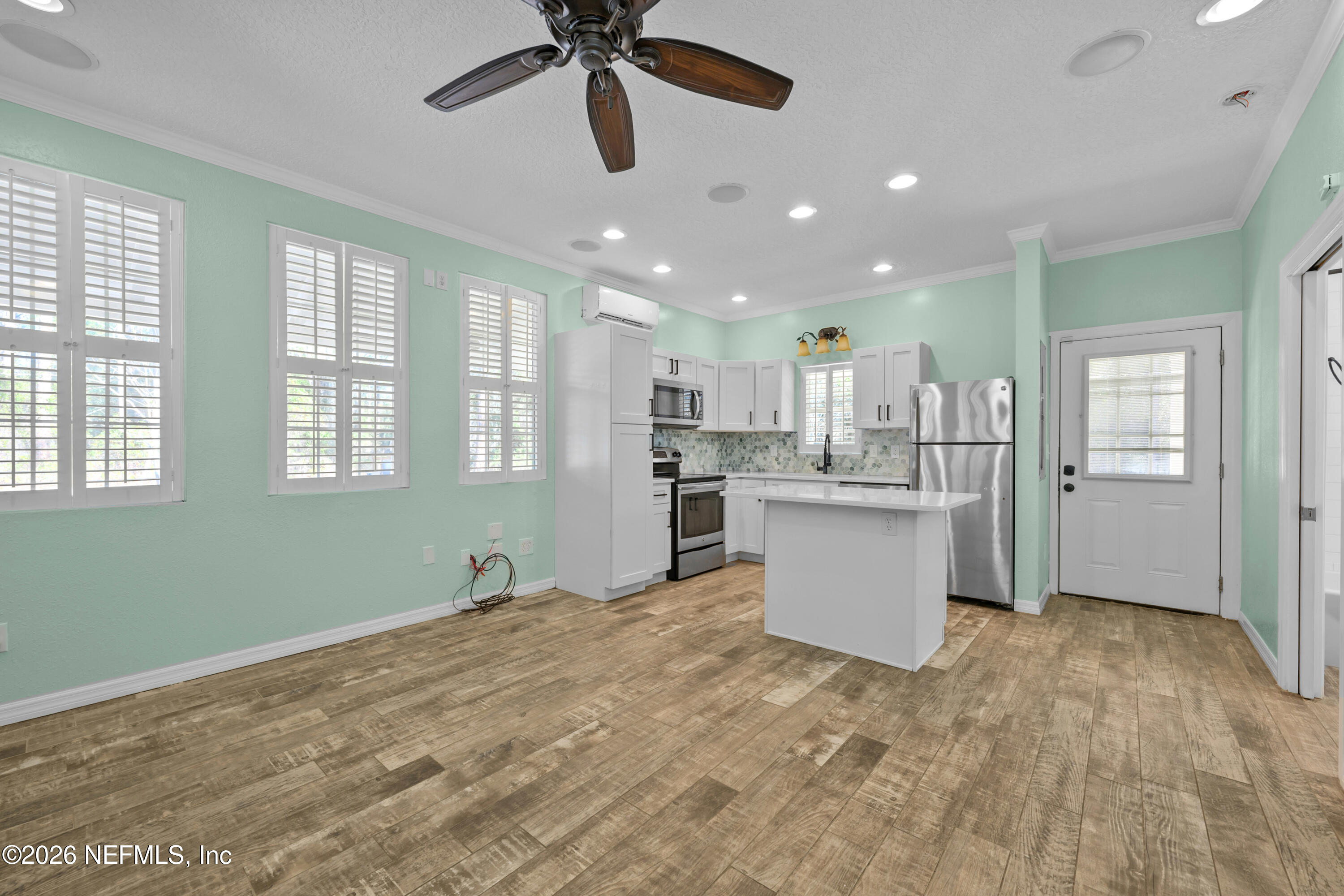 179 Georgetown Denver Road Georgetown, FL 32139 - Photo 11 of 24 a room with kitchen island stainless steel appliances wooden floor and window