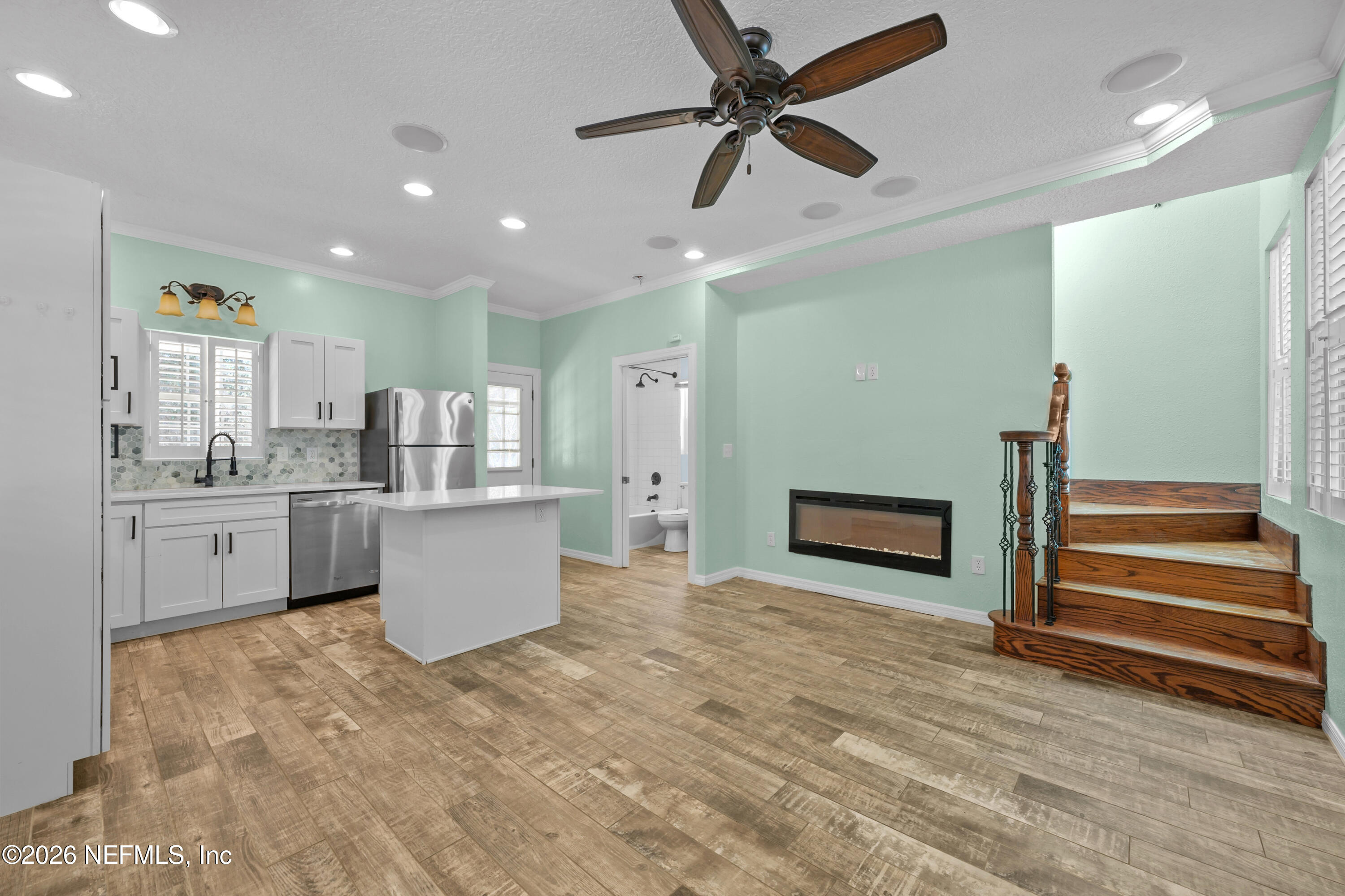 179 Georgetown Denver Road Georgetown, FL 32139 - Photo 13 of 24 a kitchen with stainless steel appliances kitchen island in the center and wooden floor