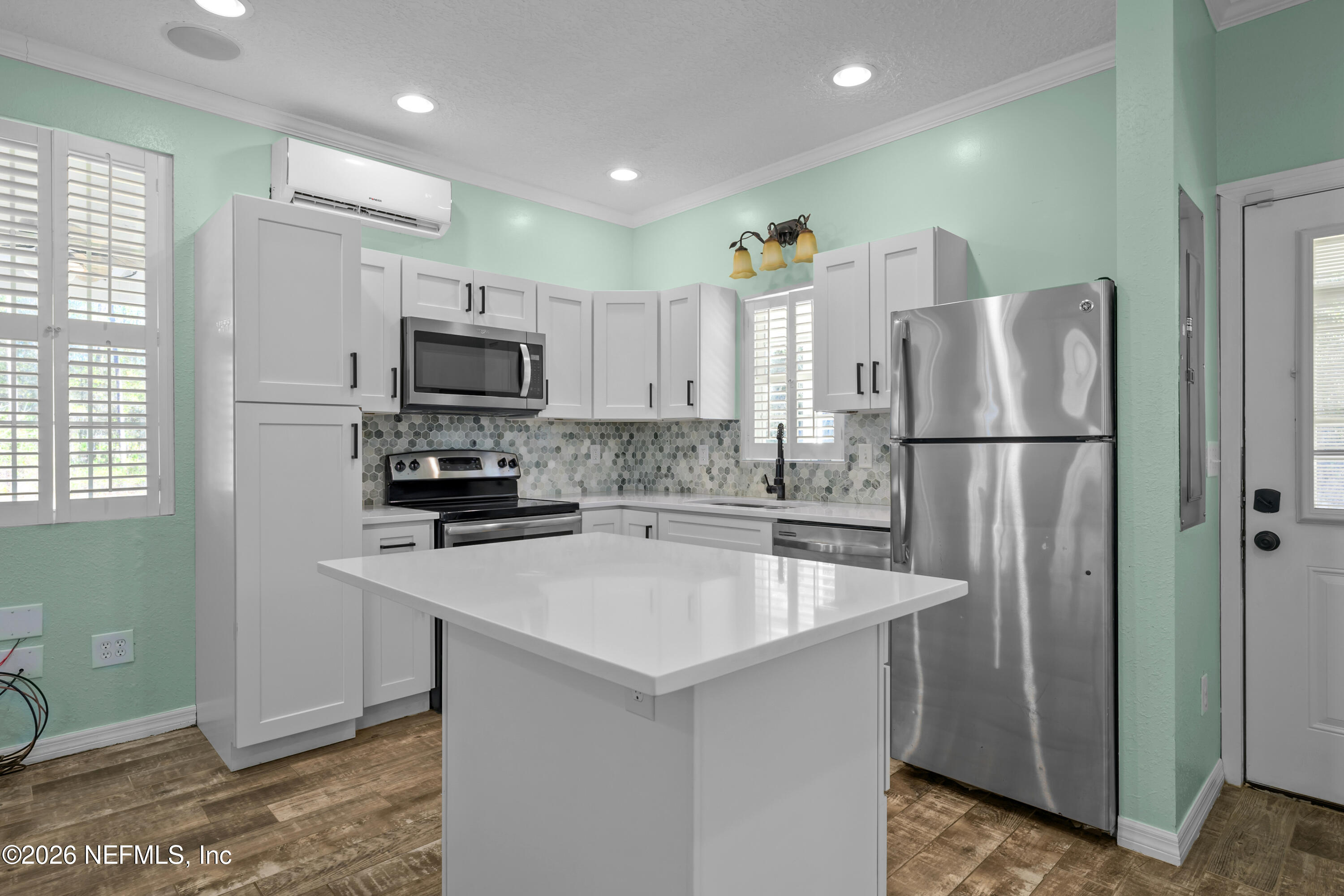 179 Georgetown Denver Road Georgetown, FL 32139 - Photo 14 of 24 a kitchen with stainless steel appliances granite countertop a refrigerator a sink a stove a microwave and island